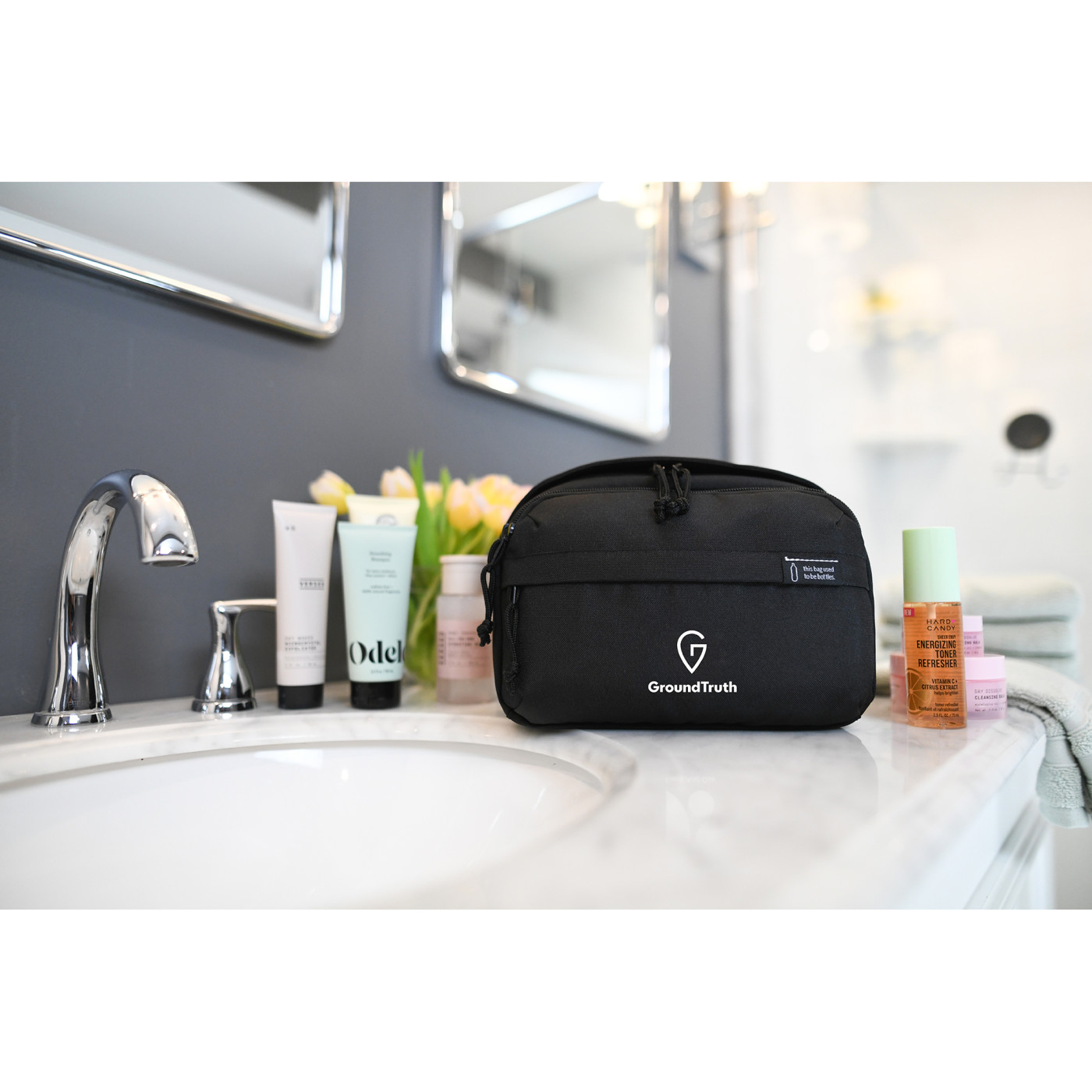 rPET Recycled Toiletry Bag in black sitting on a bathroom counter