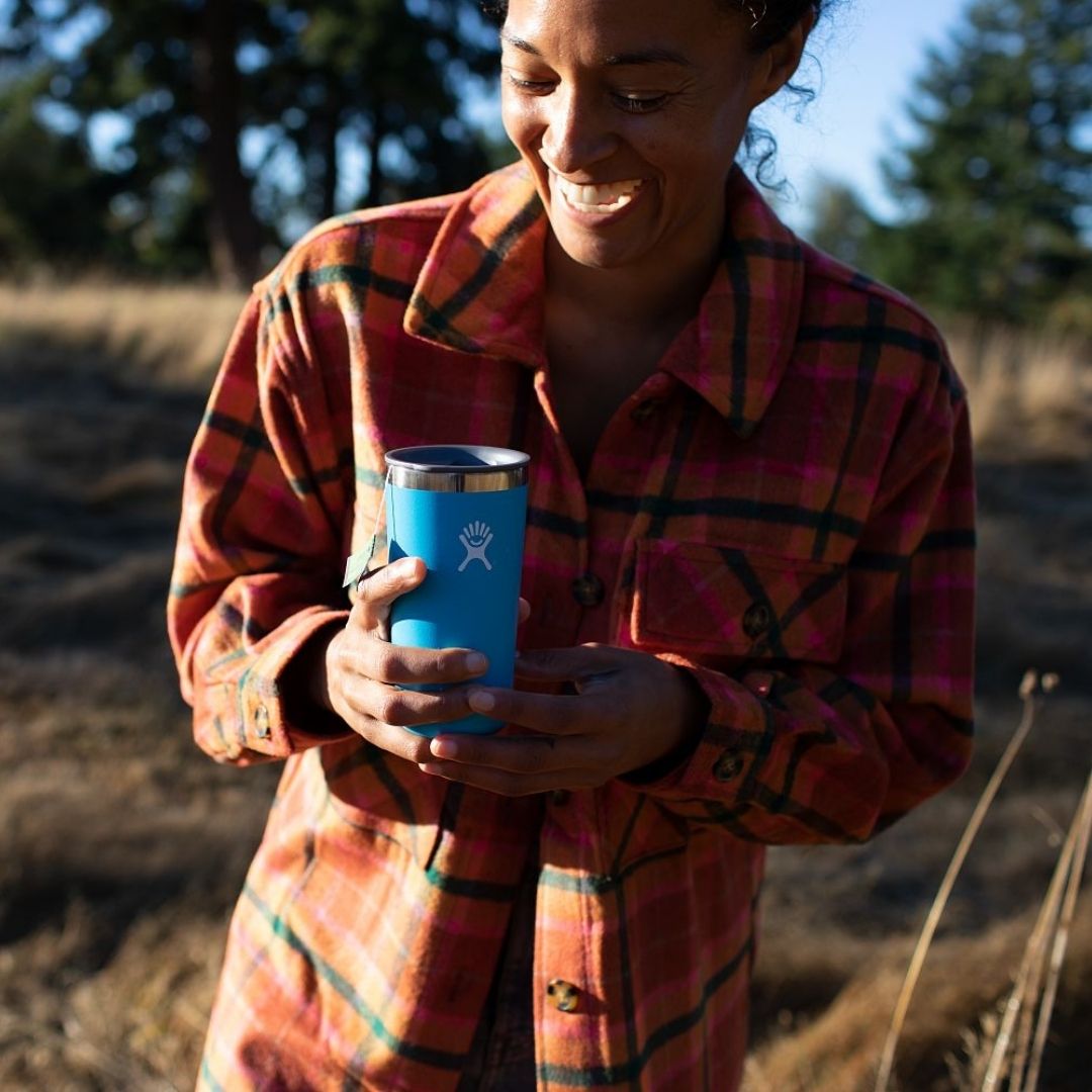 Woman in nature holding Hydro Flask® 20 oz Stainless Steel Tumbler