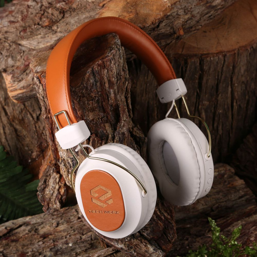 Recycled headphones sitting on tree bark