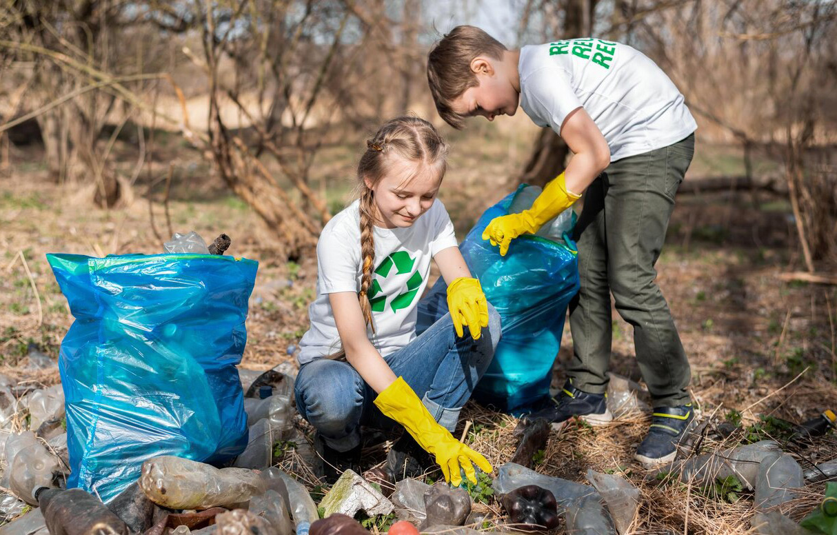 children collecting plastic garbage in the park