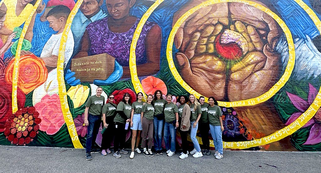 epp team group photo in front of a mural