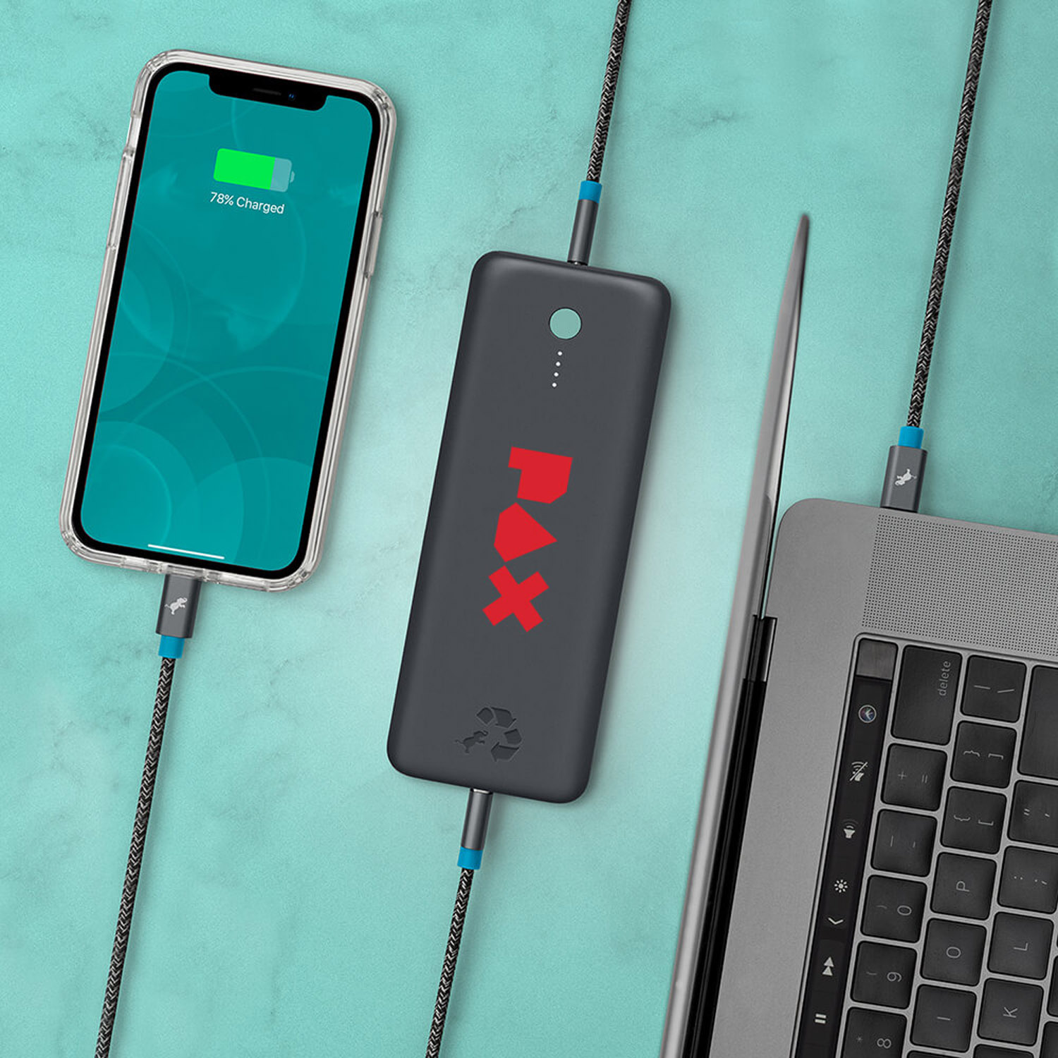 power bank actively charging a smartphone and connected to a laptop