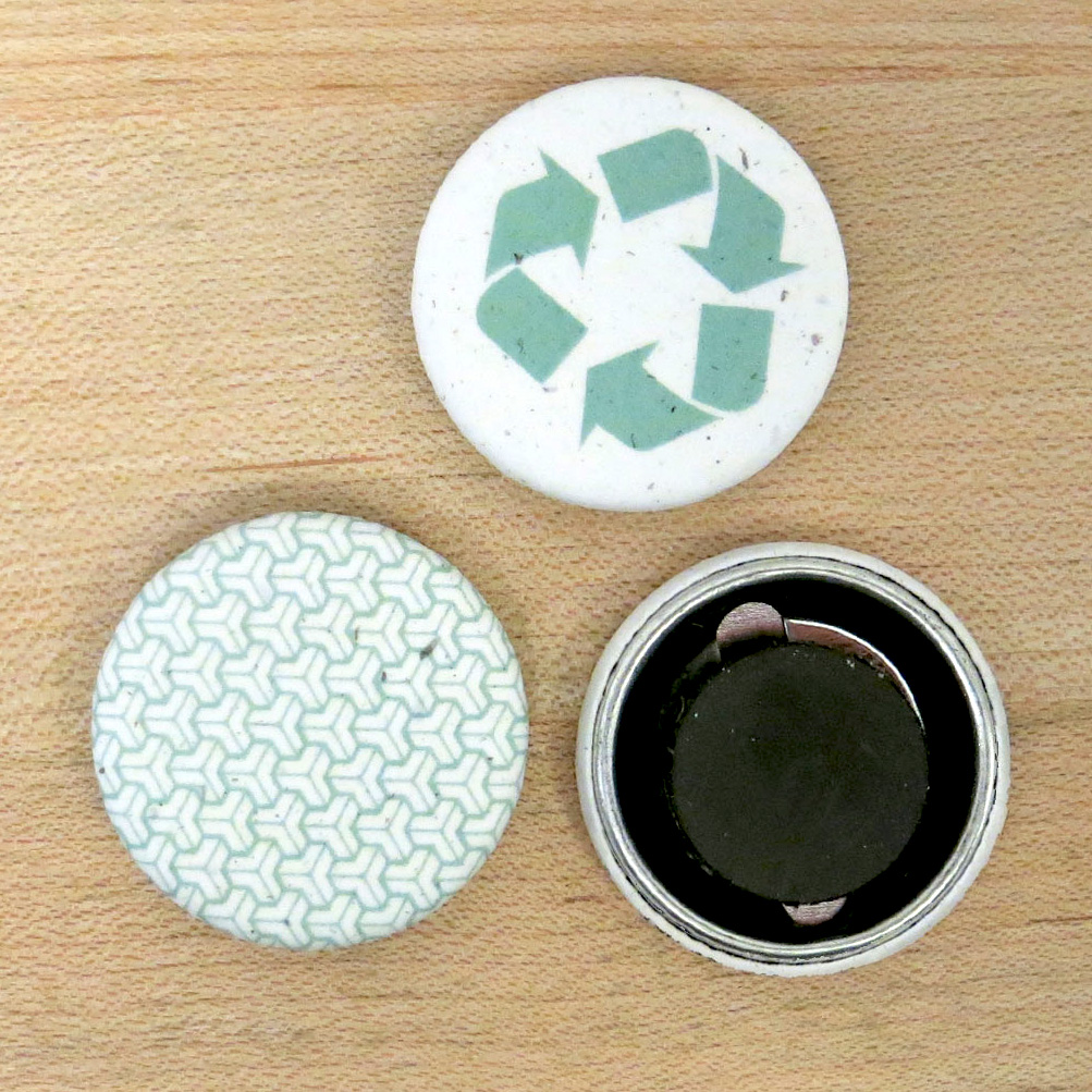 two paper magnets displaying the front designs, and one paper magnet showing the back view