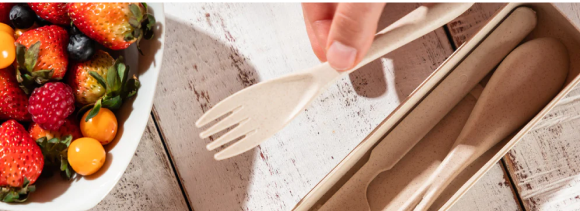 person holding a reusable fork from a utensil set